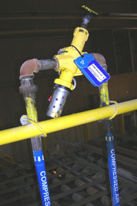 Pneumatic energy isolating device - can be locked and bleeds off downstream residual pressure