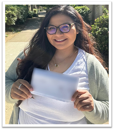 Jessica Delgado holds her check from the Labor Commissioner’s Office